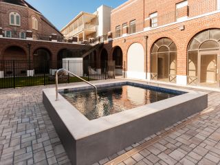 A Brick Courtyard With A Fountain In It
